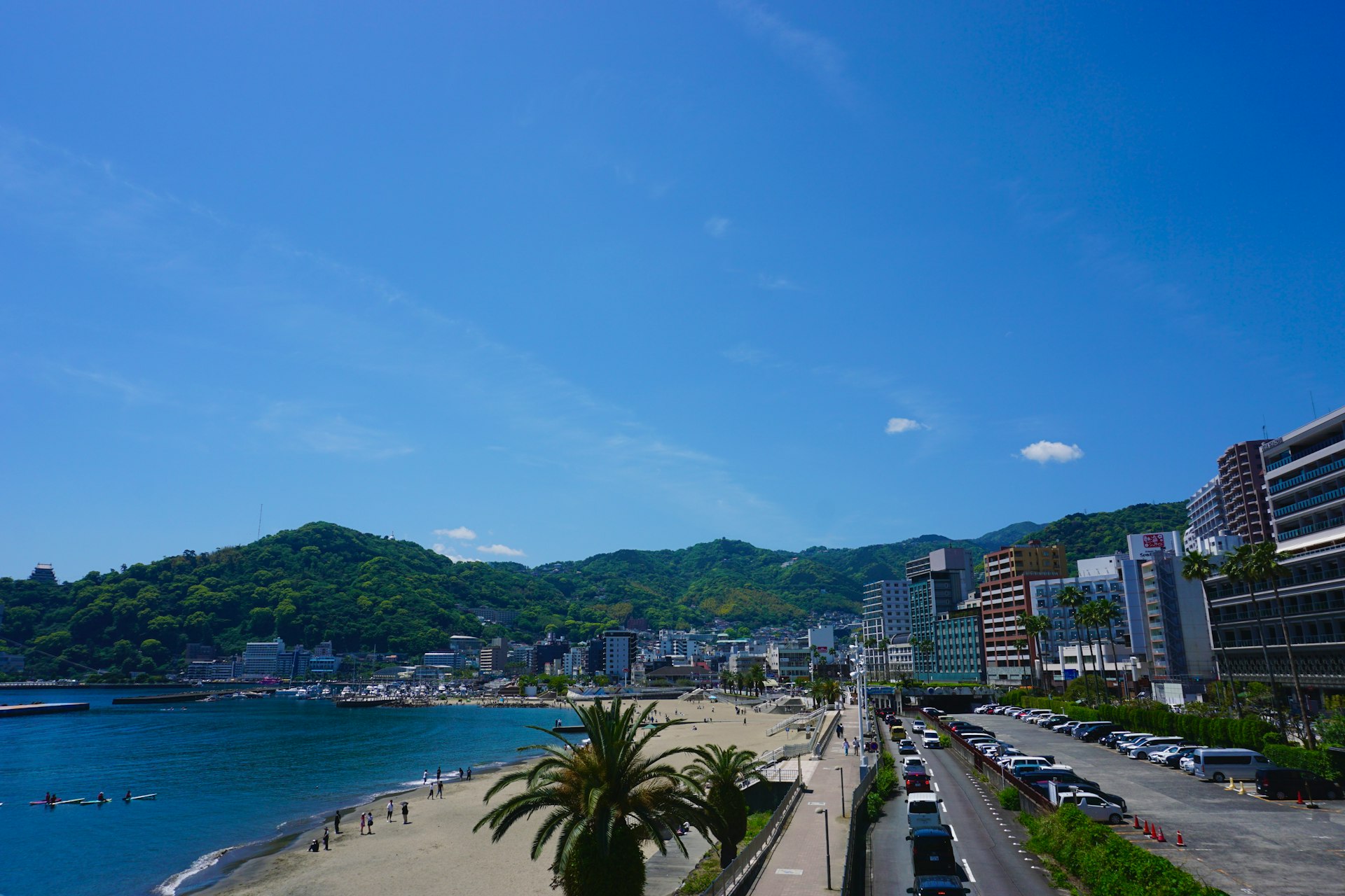 a beach with cars parked on the side of it